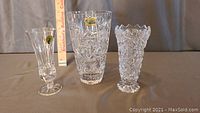 Three lead crystal vases side-by-side with a measuring stick showing sizes from 5 1/2 to 7 inches