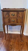 Full view of the small antique American solid wood side table showing wood grain and leg details.