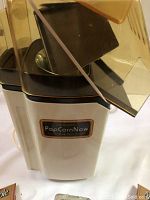 Presto PopCornNow hot air popcorn popper with transparent lid showing popcorn chamber