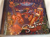 Santana CD with colorful and artistic cover design featuring musical instruments.