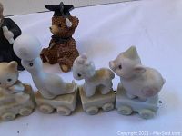 Graduation figurine and animal train set shown in full from side angle