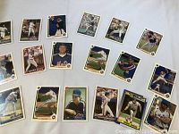 Photo of 16 New York Mets baseball cards spread out showing various players pitching, hitting, or posing.