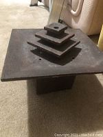 Side angle view of the Zen water fountain showing tiered square layers on top of a square base with a textured dark finish.