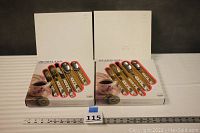 Two boxed unopened sets of Heartland stainless steel flatware, visible sets of forks, knives, spoons with printed white handles.