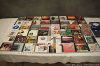 Top-down view of 50 assorted classical music CDs laid out on a table showing album cover art.
