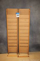 Front view of the two light oak magazine racks side-by-side showing all compartments and shape