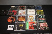 Overview of all 13 PlayStation game discs and jewel cases arranged in rows showing cover art and disc labels.