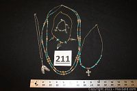 Full view of all 4 necklaces and 1 bracelet arranged with ruler for size reference