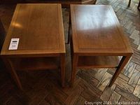 Two wood end tables side by side on parquet floor