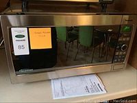 Front view of Panasonic microwave showing stainless steel finish and model note 1.6 cu ft capacity.