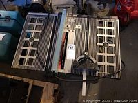 Top-down view of saw showing tabletop grid, fence rail and power cord