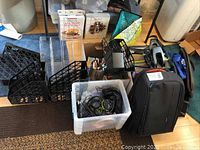 Various office organizers and bags along with a clear bin of headphone sets