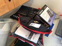 Overview of lot showing AMX7333 mixer, Tascam US-122MKII box and two zippered carrying cases