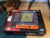 Boxes of Akai APC40 and Novation Launchpad S placed on floor