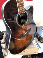 Front view of guitar body showing sunburst spruce top and Venetian cutaway