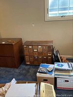 Front view of wooden cabinet with two rows of seven drawers each