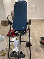 Full view of Hangups Inversion Table showing black metal frame and padded backrest