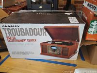 Crosley Troubadour USB/SD Entertainment Center in original box with product image and branding visible.