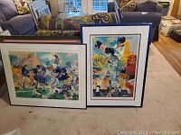 Both framed prints leaning against couch