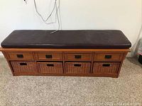 Front view showing four top drawers and four wicker baskets with cushion on top