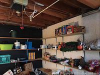 Shelves with plastic storage bins, small crates, baskets, and assorted holiday decorations including Christmas boxes and wreaths