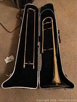 Full view of the Blessing trombone inside its black molded carrying case with soft lining.