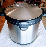 Closed view of the Tiger Thermal Magic Cooker showing stainless steel outer body with black plastic handles and secure lid.