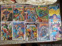 Top view of 10 vintage Superman comics from 1984 to 1987, showing front covers with various characters including Batman, Superman, and Swamp Thing.
