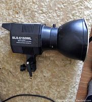 Side view of the Universal Electronics SLS-6160ML hot light showing body and reflector.