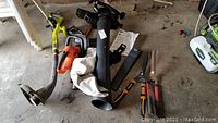 All items together showing Ryobi weed wacker, Toro blower vac, Black & Decker hedge trimmer, battery charger, two pairs of clippers
