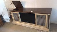 Vintage Magnavox hi-fi cabinet with wood top, lattice front doors, and built-in 32 inch Samsung TV.