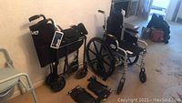Two black Drive brand steel transport wheelchairs, some with footrests detached, folded Lumax foldable aluminum walker with black cushioned seat and storage pouch.