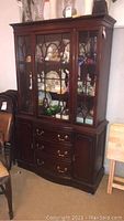 Full view of the hutch display cabinet showing upper glass doors and lower drawers and side cabinets.