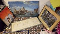 Photo showing four framed art pieces including the canvas print of Venice, floral embossing collection, and two additional prints or paintings.