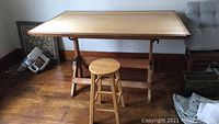 Front view of the drafting table with matching stool in front