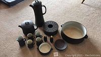 Full collection of Dansk Flame Stone Brown pottery items on carpet floor showing coffee pot, teapot, bowls, plates, shakers, and cups.