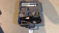 Top-down view of Dremel rotary tool and accessories in grey molded carrying case