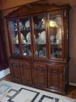 Front view of two-part display cabinet with contents inside.