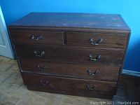 Full view of the 1940 antique wooden storage hutch showing top surface and front drawers with metal handles.