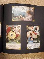 Open black album with three vintage WWI postcards mounted on right page showing women, roses, hearts, and text verses.