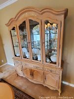 Full view of French oak glass doored hutch with contents (not included)