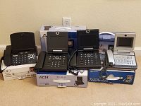 Five video internet phones with original boxes arranged in two rows on a flat surface.
