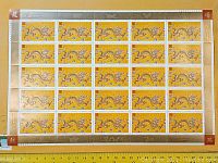 Full view of a full sheet of 25 Canadian Year of the Dragon stamps from 2000 with golden borders and dragon imagery.
