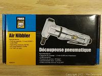 Front of the box showing product branding, specifications, and image of the air nibbler tool.