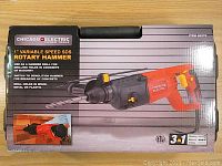 Front of boxed Chicago Electric 1" variable speed SDS rotary hammer drill showcasing product image and features