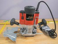 Front-left side view of Max Power router showing side handle, base, and control switch.