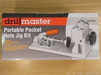 Front view of Drill Master Portable Pocket Hole Jig Kit box showing product image and list of included items.