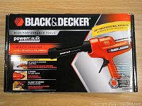 Front view of the Black & Decker Powercaulk cordless caulk gun box showing branding and product features such as two speeds, no-drip tip design, and battery requirement.