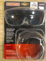 Craftsman Palm Grip Laser Level Model 992560 sealed in original packaging with included black laser safety glasses visible within packaging.