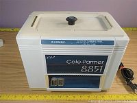 Front view with lid closed and power cord visible